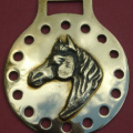 Stamped back plate with applied cast horse head